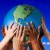 PHOTO: Hands holding world. Image by Royalty-Free/Corbis.