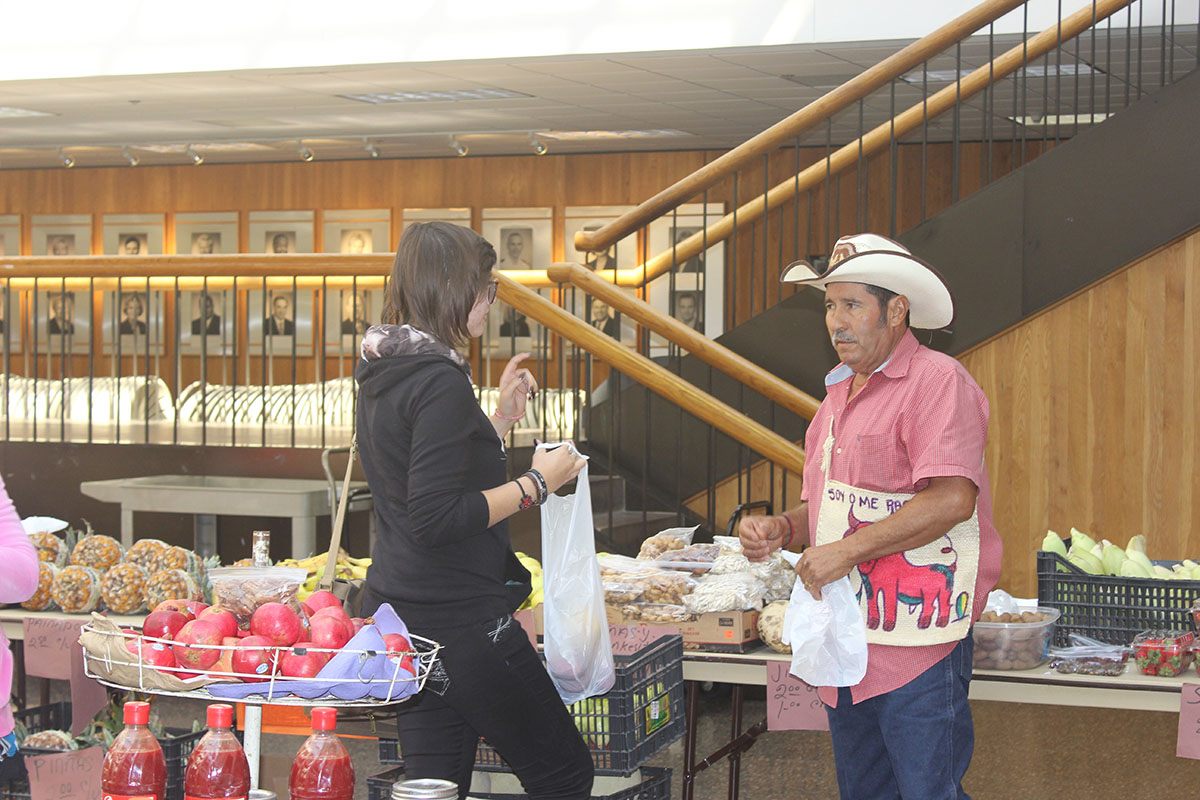 PHOTO: Jose Mireles helps a customer buy fresh fruit Photo by the Signal reporter Jaimy Jones