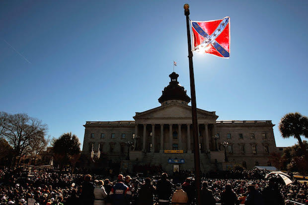 Photo: A Confederate flag that's part of a Civil War memorial on the grounds of the South Carolina State House flies over a Martin Luther King Day rally Jan. 21, 2008 in Columbia, S.C. All three major Democratic candidates for President spoke to a large crowd on the state house grounds. Photo courtesy of Chris Hondros/Getty Images.