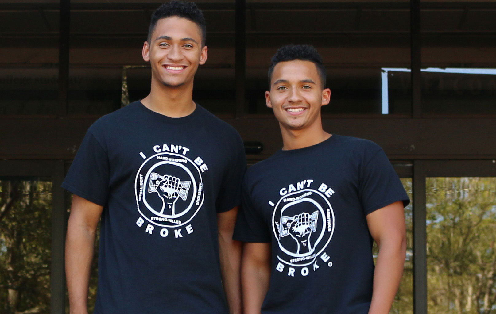 Photo: Joey LeBeau-Harrison and Foster LeBeau-Harrison stand in front of the Bayou Building wearing their custom made "I can't be broke" T-shirts. Photo by The Signal reporter Brandon Peña.