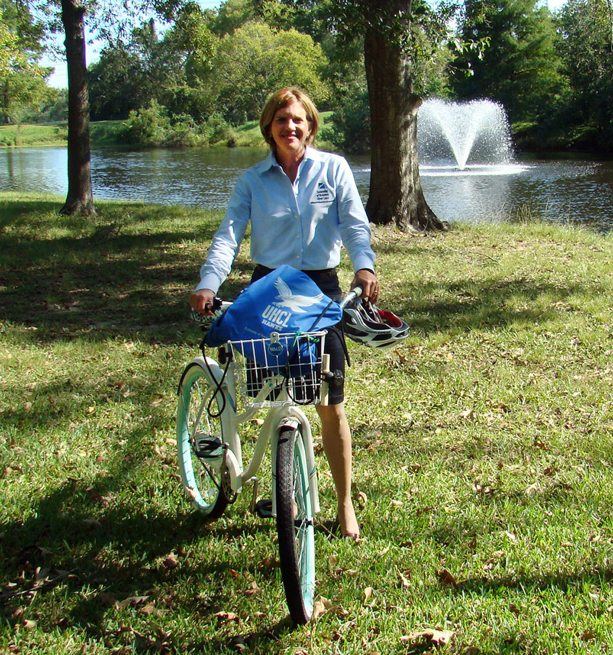 Image: Karen Barbier, associate director of university communications-media relations, on her bike that she rides to work by the pond. Photo by The Signal reporter Kyle Upton.