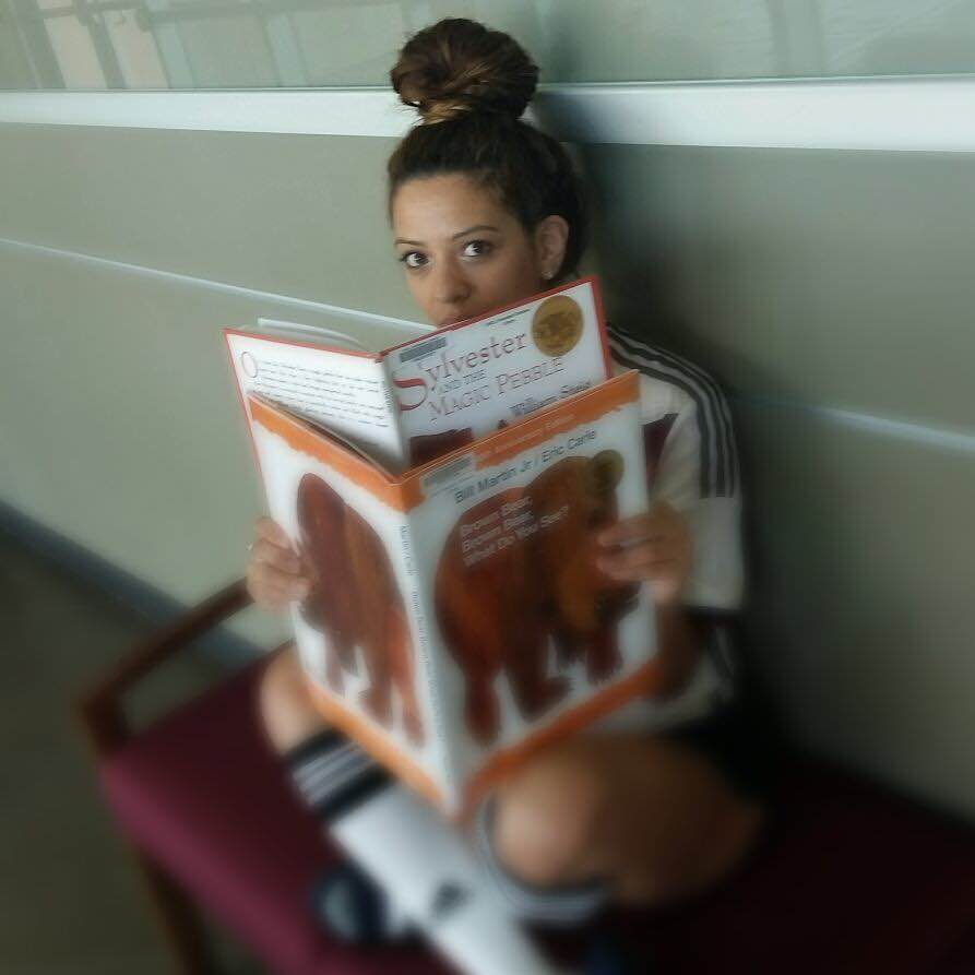 Photo: Alexa Perez reading "Sylvester and the Magic Pebble" written and illustrated by William Steig