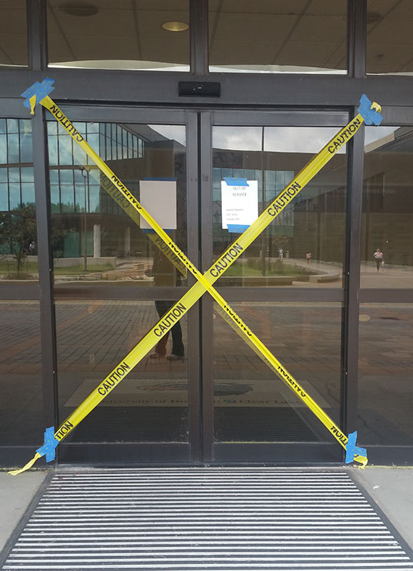 Photo: Sliding glass doors to Bayou Building from Alumni Plaza in disrepair. Photo by The Signal Reporter Amethyst Gonzalez.