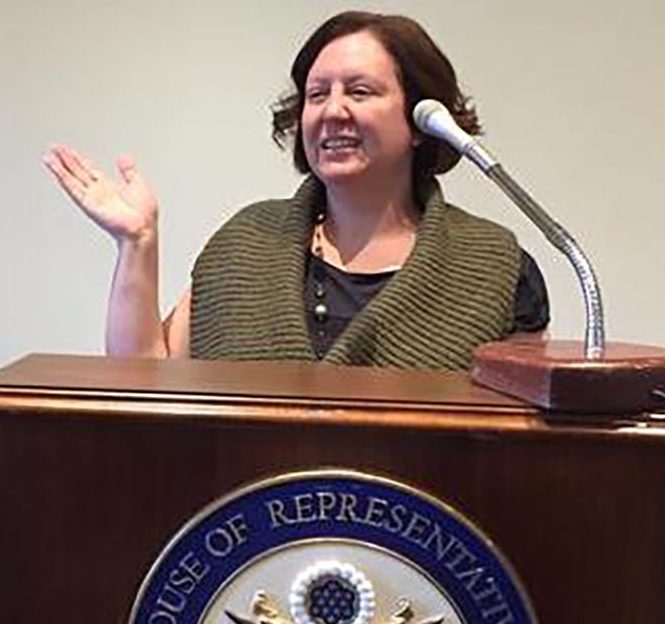 Photo: Kim Case presenting to US Congress. Photo courtesy of: The Society for the Psychological Study for Social Issues.
