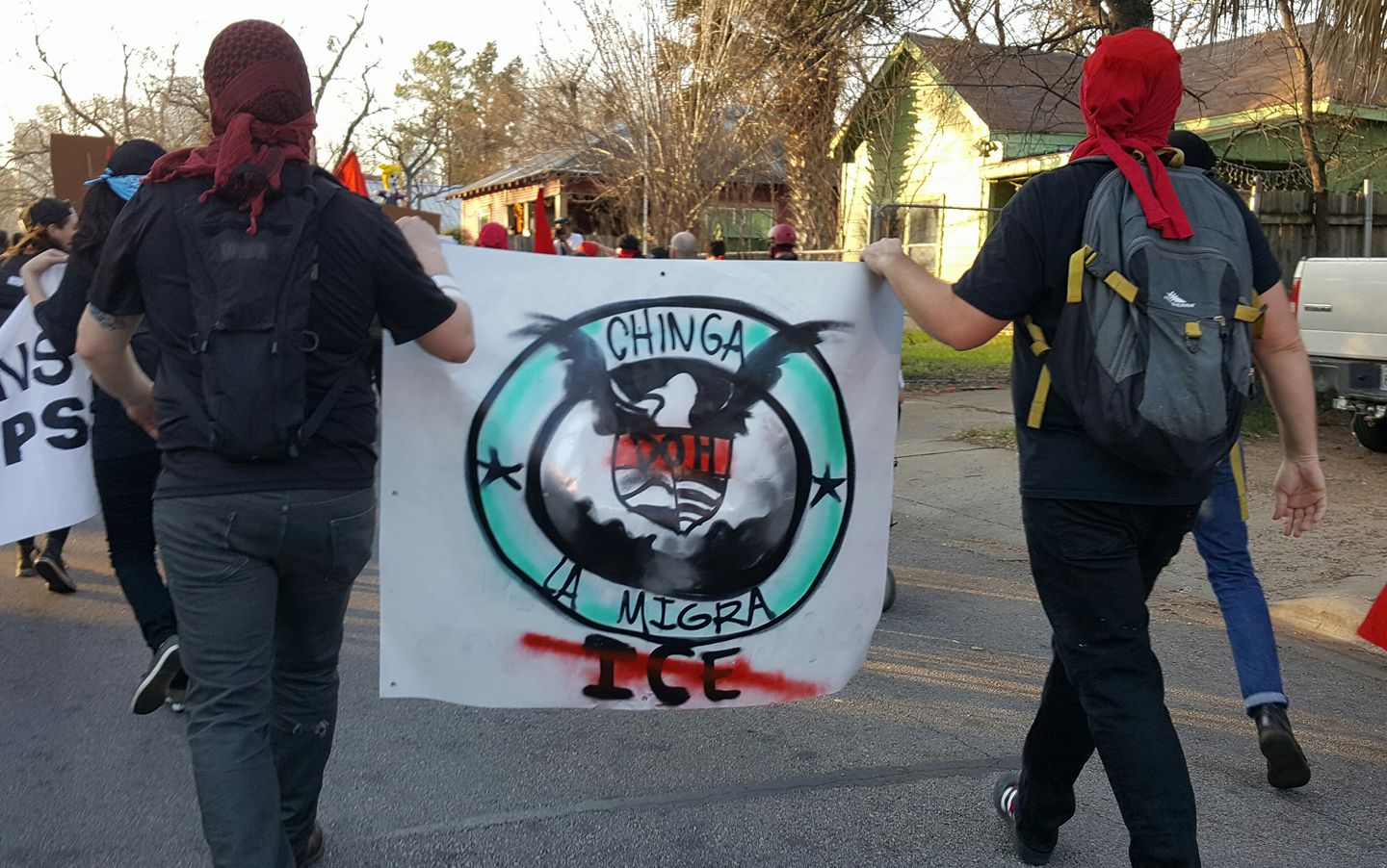 PHOTO: Two protesters in Austin carry a sign in opposition to the recent ICE raids. Photo courtesy of Kit O'Connell.