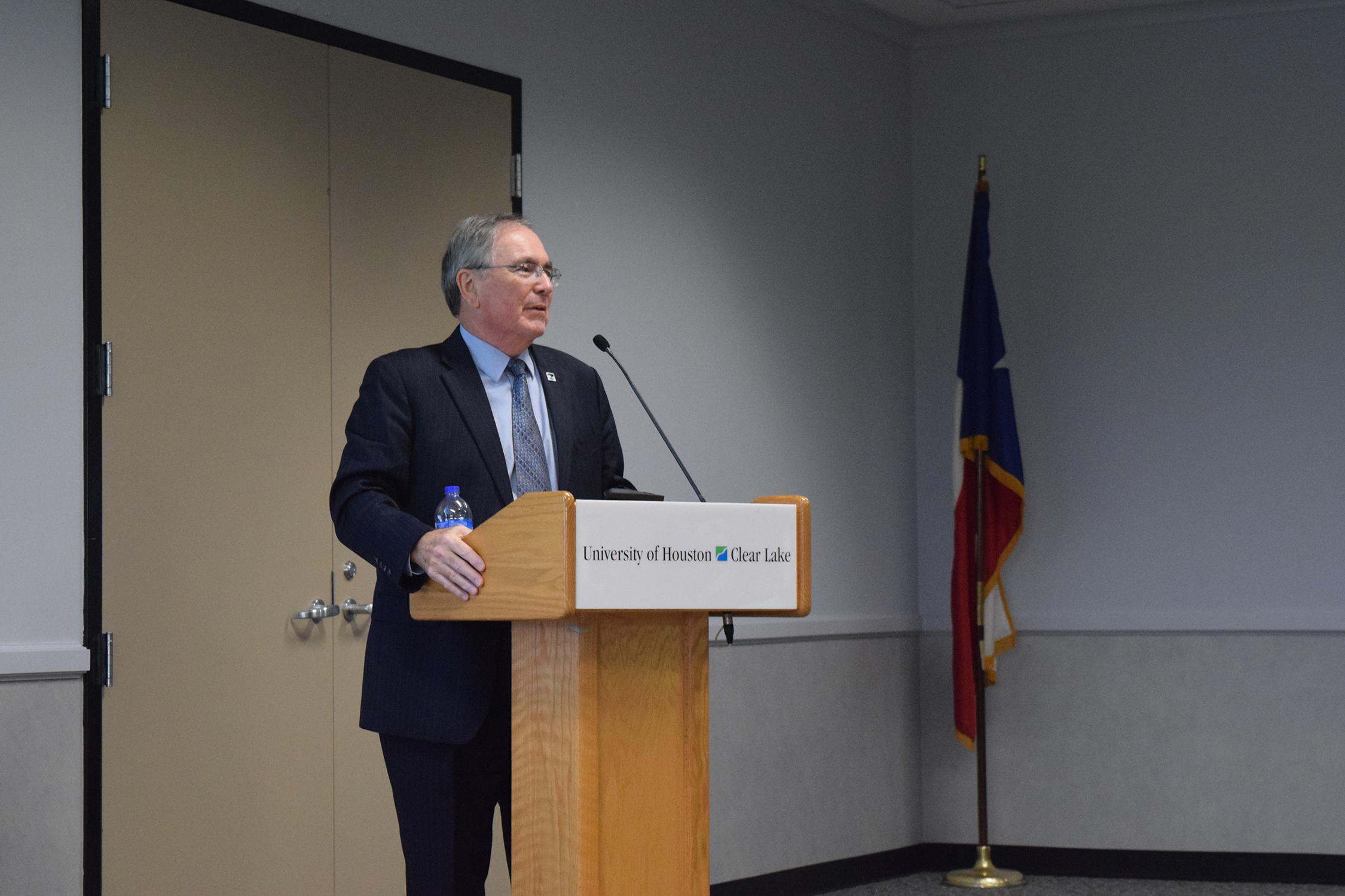 Photo: President William Staples speaks at a podium about the university budget gap at a meeting Feb. 9. Photo by The Signal reporter Krista Kamp.