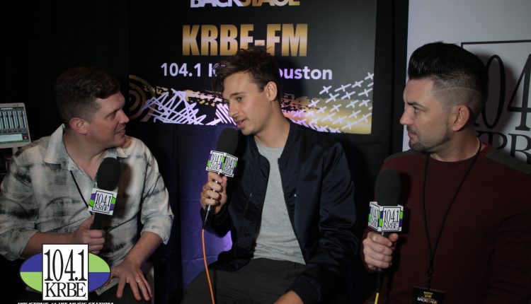 PHOTO: 104.1 KRBE DJ's Special K and Kevin Quinn interview Flume on Radio Row. Photo courtesy of E.J. Santillan and 104.1 KRBE.