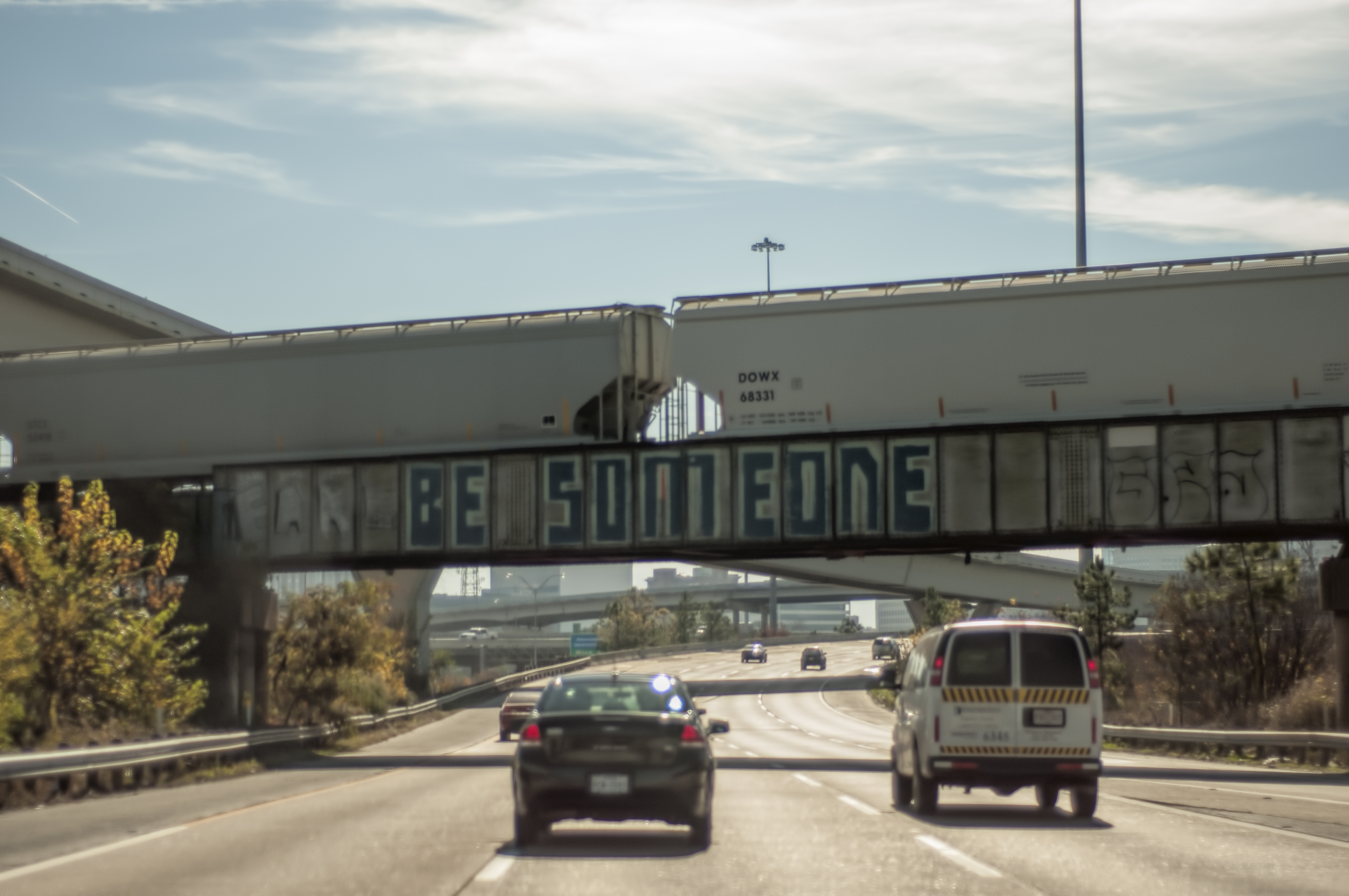 The bridge over I-45 with the "be someone" graffiti. Photo courtesy of Flickr user optictopic.