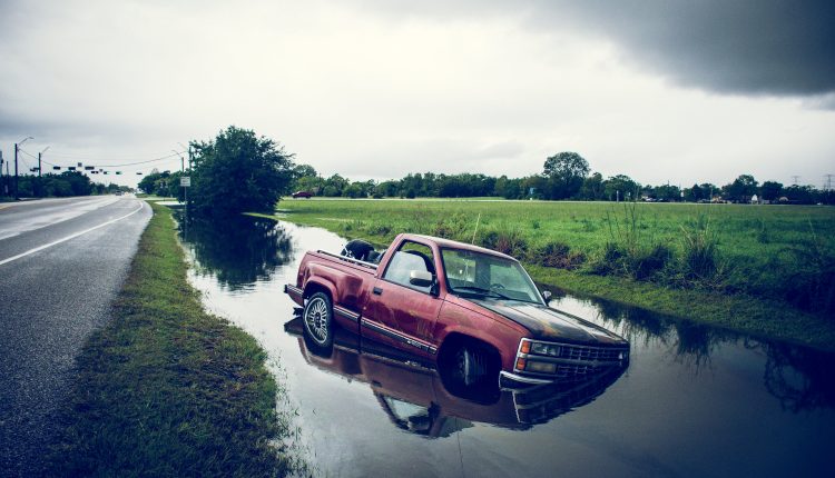 PHOTO: A truck submerged in flood waters on the side of FM 646 in Dickinson, TX. Photo by Audience Engagement Coordinator Regan Bjerkeli.