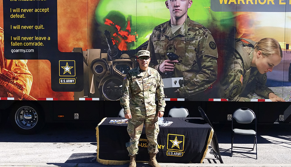 Sergeant Navarro in front of The Army American Soldier Semi. Photo courtesy of The signal reporter Micaela Kinsey.