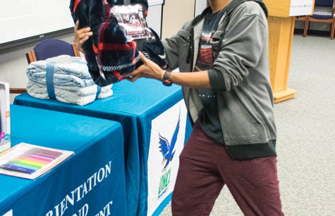 Luis Arturo Perez, biological sciences major and member of the Pre-Health and Science Association, holding his prize during the 2017 Bingo and Breakfast event. Photo by Audience Engagement Coordinator Regan Bjerkeli.