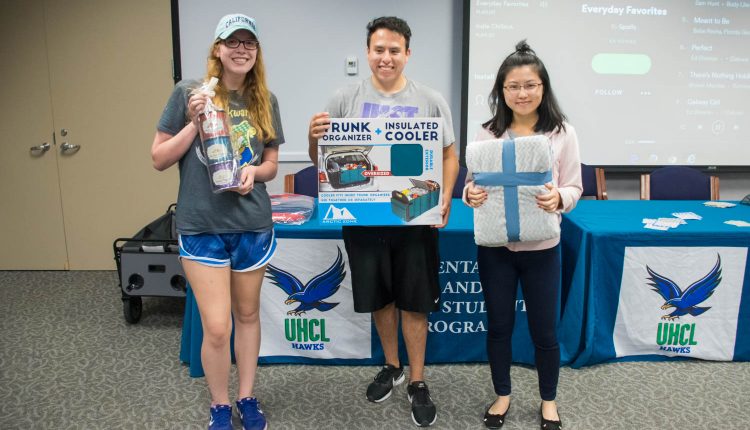 PHOTO: (from left to right) Lettisha Omo, standards officer for Delta Xi Nu, Rachel Liao, member of the Family Therapy Student Association, and Jesus Guadarrama, member of Bilingual Education Student Organization and Hawk leadership institute, holding their prizes and the 2017 Bingo and Breakfast event. Photo by Audience Engagement Coordinator Regan Bjerkeli.