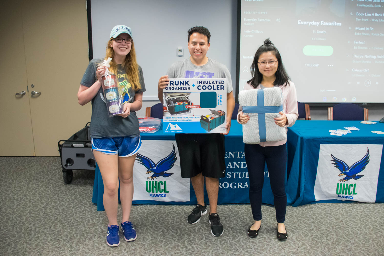 PHOTO: (from left to right) Lettisha Omo, standards officer for Delta Xi Nu, Rachel Liao, member of the Family Therapy Student Association, and Jesus Guadarrama, member of Bilingual Education Student Organization and Hawk leadership institute, holding their prizes and the 2017 Bingo and Breakfast event. Photo by Audience Engagement Coordinator Regan Bjerkeli.