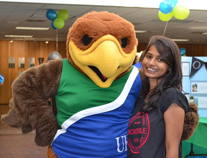 Payal Rajpurehit, computer science major, poses with Hunter the Hawk at this year's I Heart UHCL Day. Photo by The Signal reporter Becky Shafter.