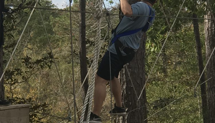 Student Body President Justin Murphy carefully calculates his next move on the tight rope obstacle. Photo courtesy of Diveanne Martinez, SGA Vice President - Committee Coordinator.