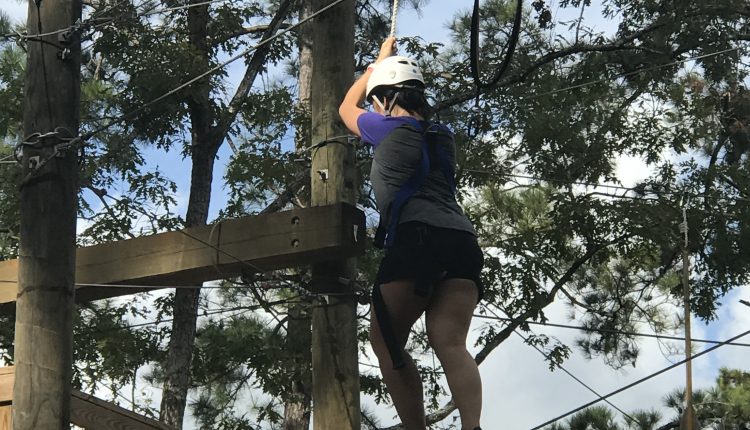 Kristy Nguyen holds on tight to the support string as she tip-toes across the tight rope obstacle. Photo courtesy of Diveanne Martinez, SGA Vice President - Committee Coordinator.