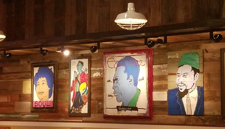 Colorful artwork featuring famous jazz musicians line the wall of the dining area. Photo by The Signal reporter Bianca Salazar.