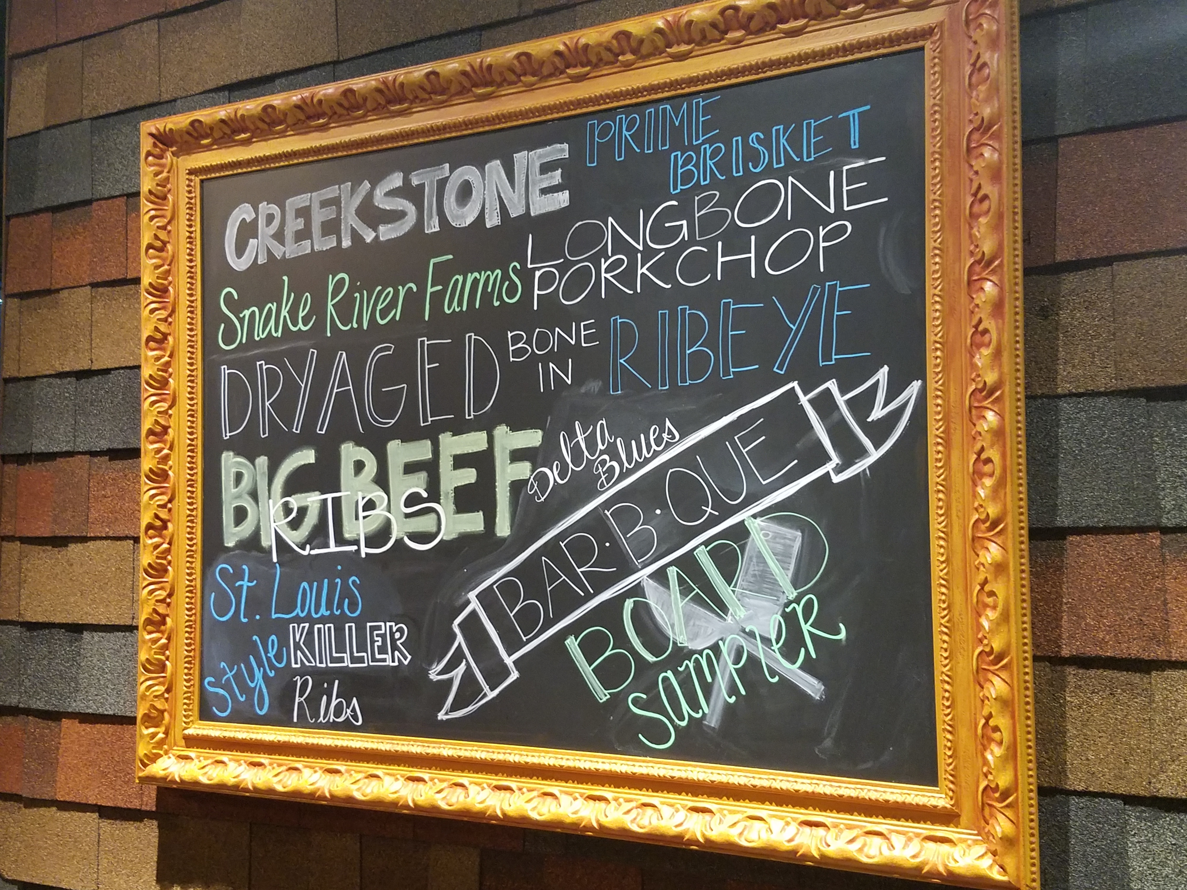 A chalkboard sign outside the restaurant featuring signature menu items. Photo by The Signal reporter Bianca Salazar.