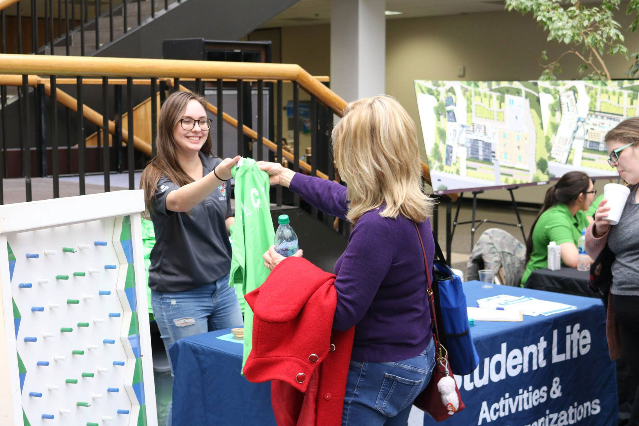 PHOTO: Makayla Ellis, student associate of student life, gives out free T-shirts at the spring 2018 Student Organization Expo. Photo courtesy of Student Life Office.
