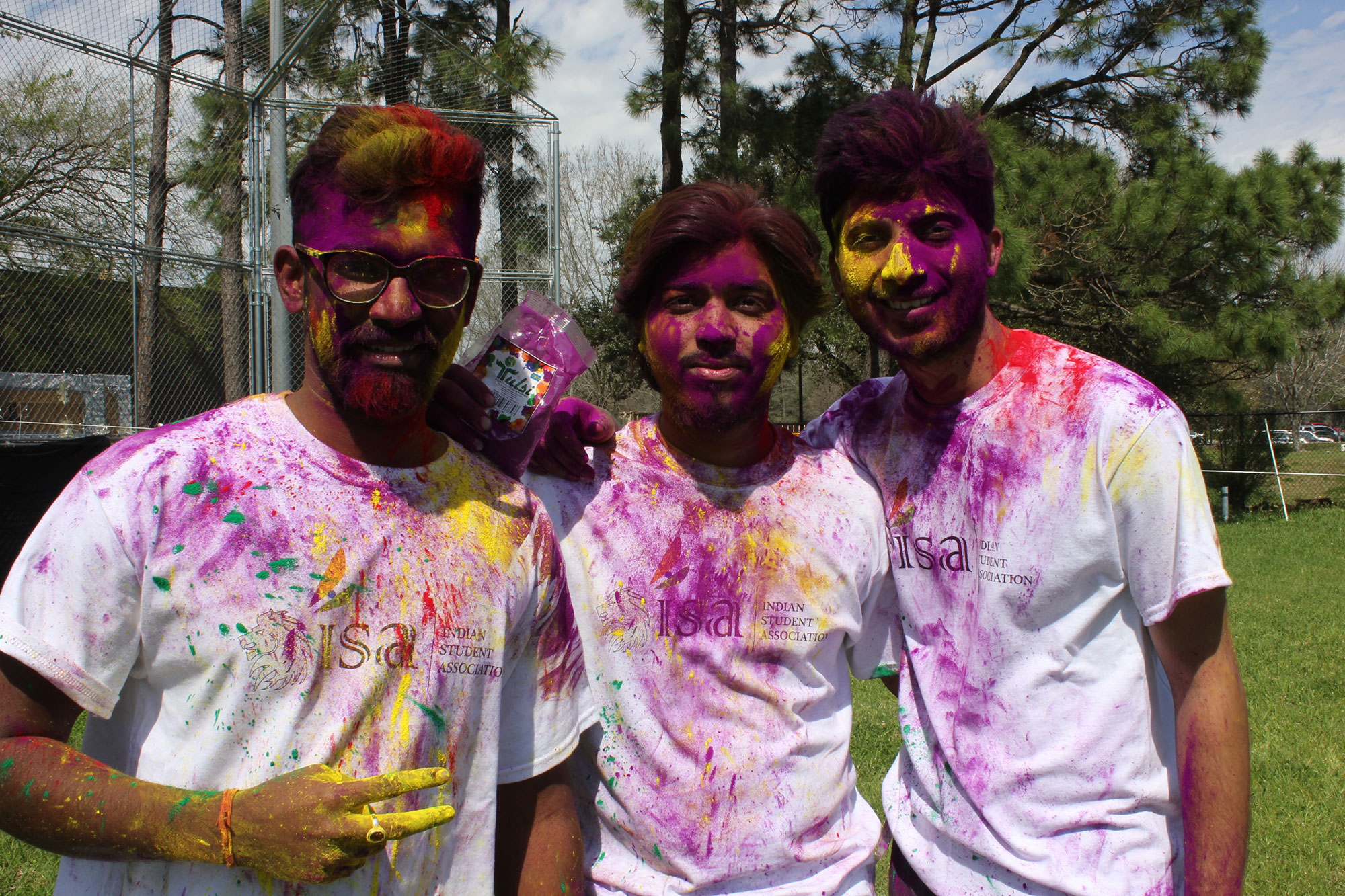 Photo: Ashish Shukla, Management Information Systems Major; Harshal Wasekar, Management Information Systems major; and Parvez Salim, Software Engineering Major, stand covered in purple powder for Holi Friday, Mar. 2nd at the Delta Recreational Field. Photo by The Signal reporter Courtney Cryer.