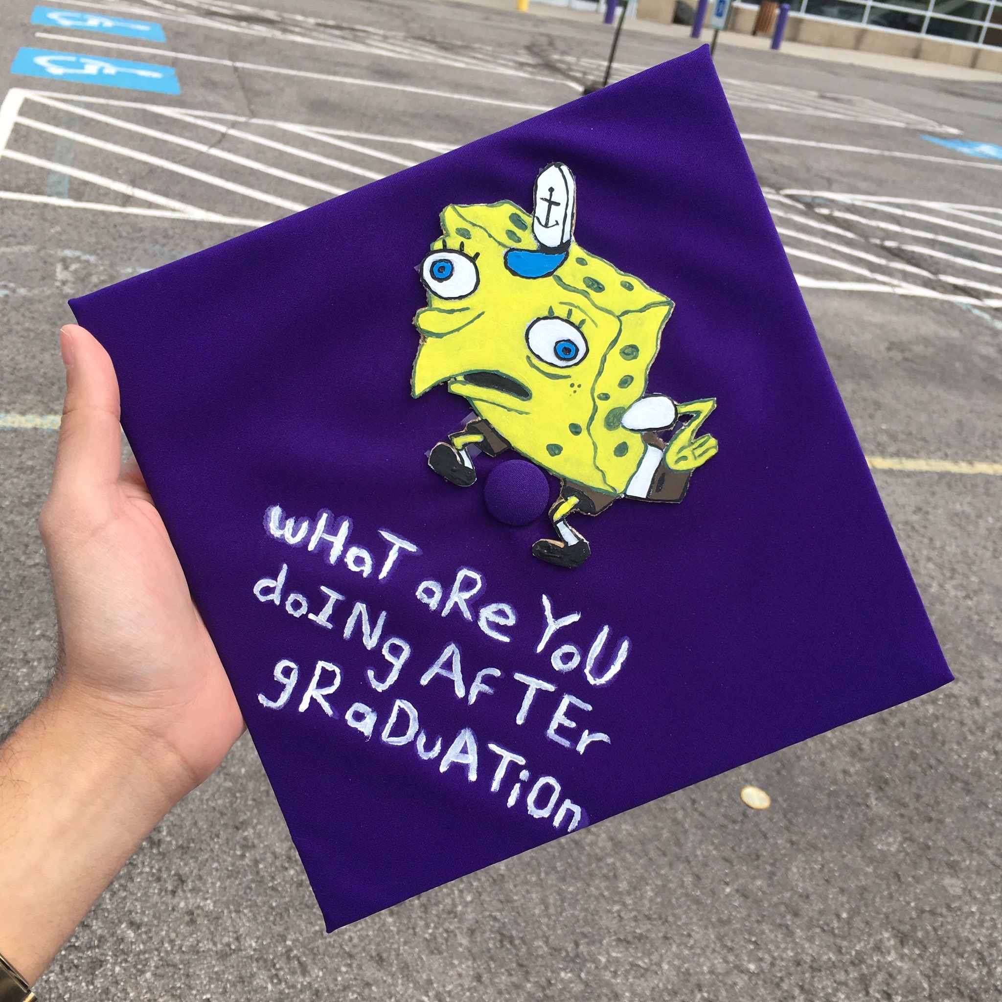 Graduation Cap with a picture of Spongebob Squarepants asking "what are you doing after graduation."