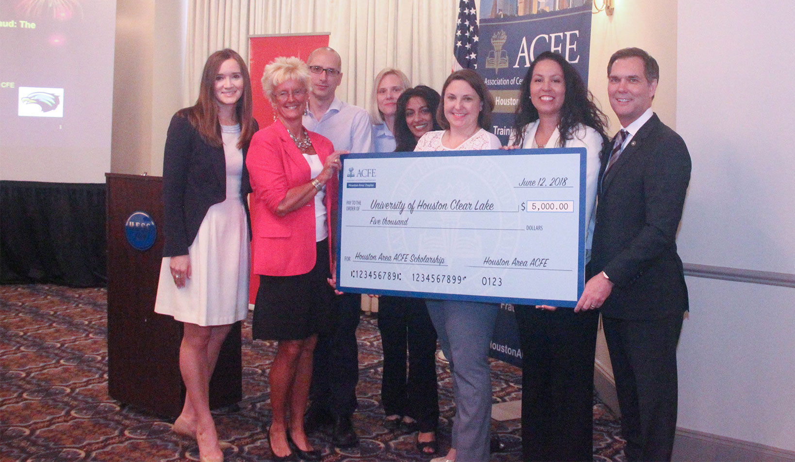 IMAGE: UHCL alumni and ACFE members hold scholarship money at June 12 meeting. Pictured from left to right: Katherine Avery Guillot, Dr. Constance Lehmann, Stephen Sutton, Gwendolyn Haley, Elbby Antony, Jessica Stansel, Chrysti Ziegler, Bruce Dorris.
