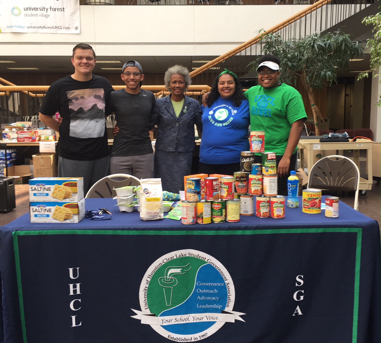Justin Murphy, Mo AbdelGilil, President Ira K. Blake, Diveanne Martinez and Izuh Ikpeama at the Hawks helping Hawks collection event in 2017. Photo courtesy of UHCL SGA.