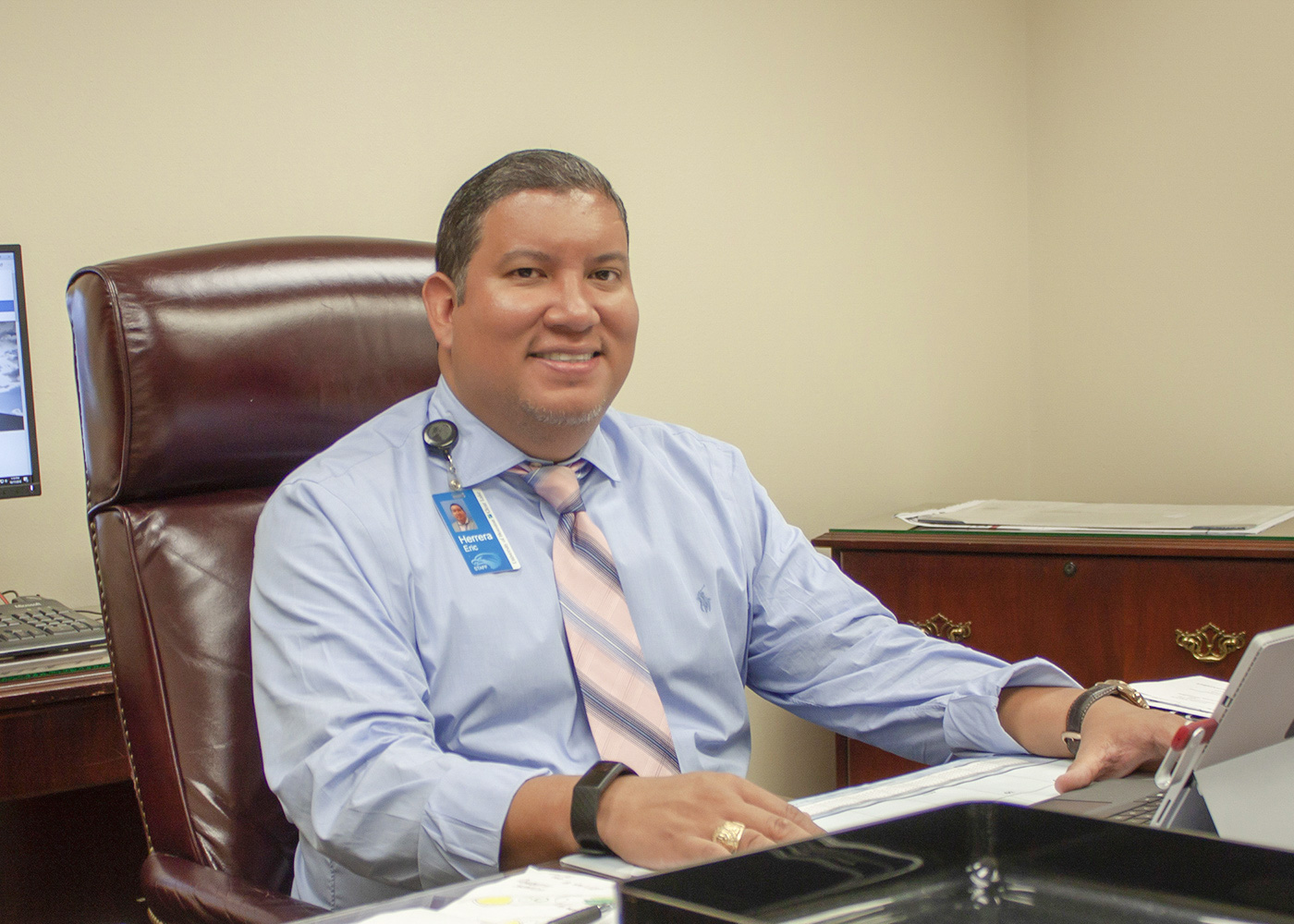 PHOTO: Eric Herrera, associate vice president for facilities management and construction, sits in his office. Photo by The Signal reporter Nhu Tran.