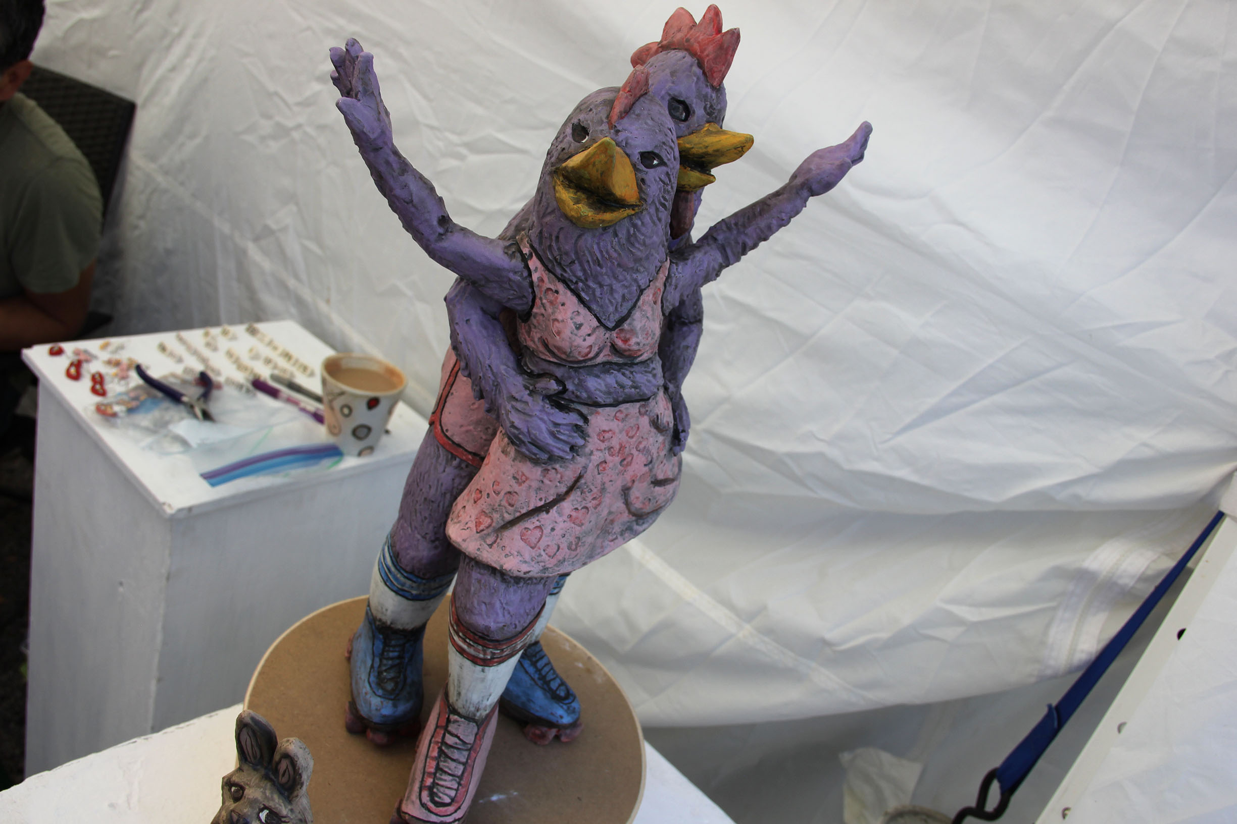 PHOTO: This 18-inch clay sculpture of purple roller skating chickens was created by artist Carol Schwartz. Traveling from right outside of San Marcos, Schwartz’s sculptural and functional ceramics focuses on storytelling. Photo by The Signal Online Editor Alyssa Shotwell.