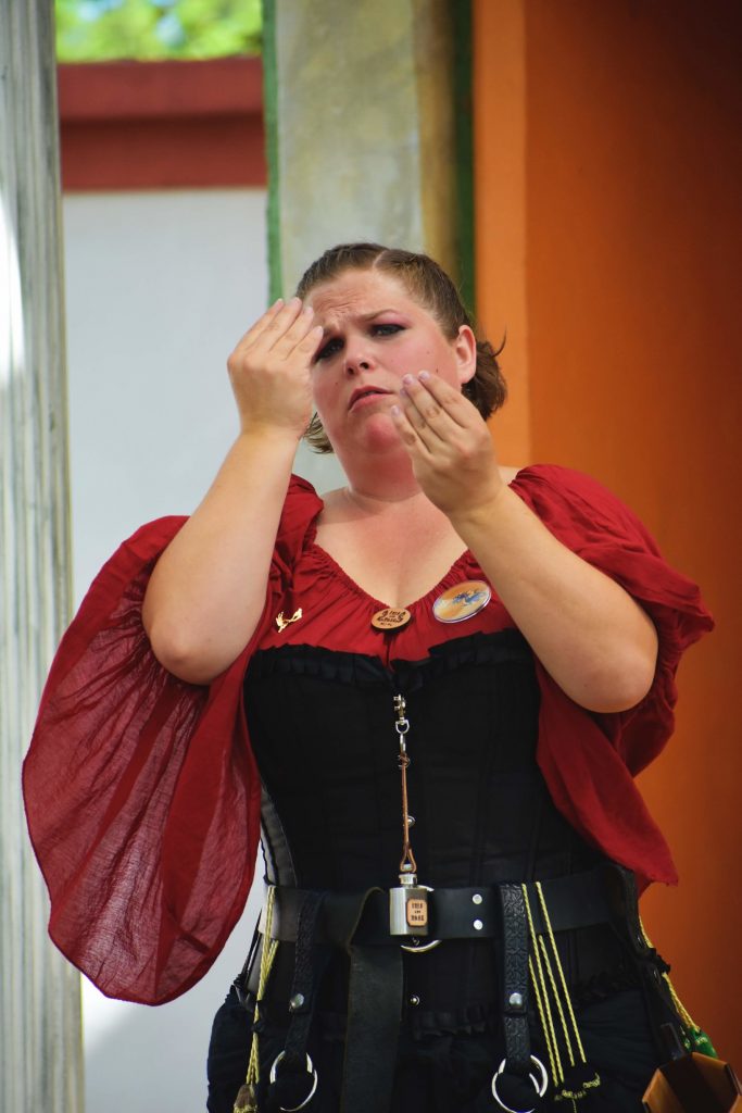 PHOTO: Texas Renaissance Festival American Sign Language Interpreter signs to the crowd as the actors on stage do a skit. ASL is a new addition to the Festival this year. Photo courtesy of Matthew Smith