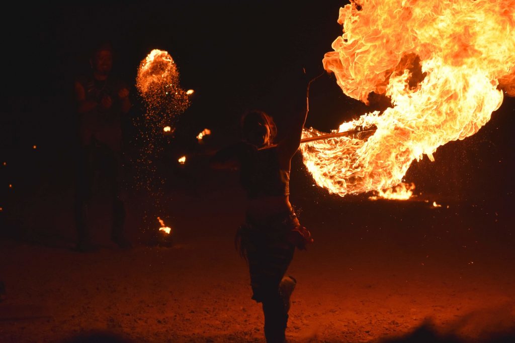 PHOTO: Fire performer of Solar Rain dances through the arena with a stick made of a bushel of fire. Photo courtesy of Matthew Smith