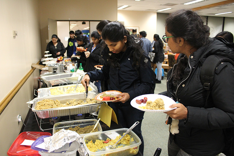 PHOTO:Friendsgiving attendees grab BOSS Friendsgiving meal.