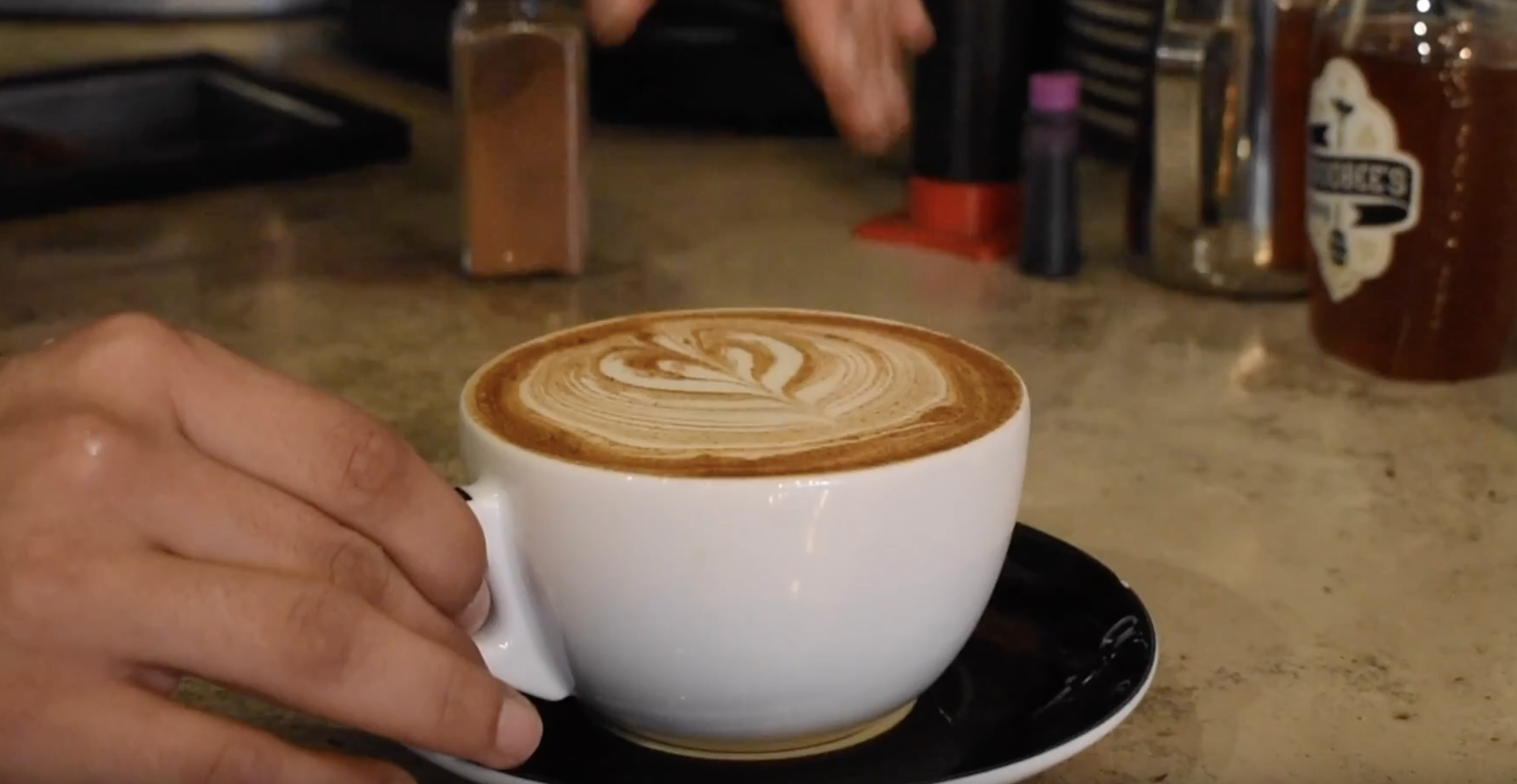 SCREENSHOT: Fix Coffeebar barista gives customer cup of coffee. Screenshot by The Signal reporter Bethany Gambino.