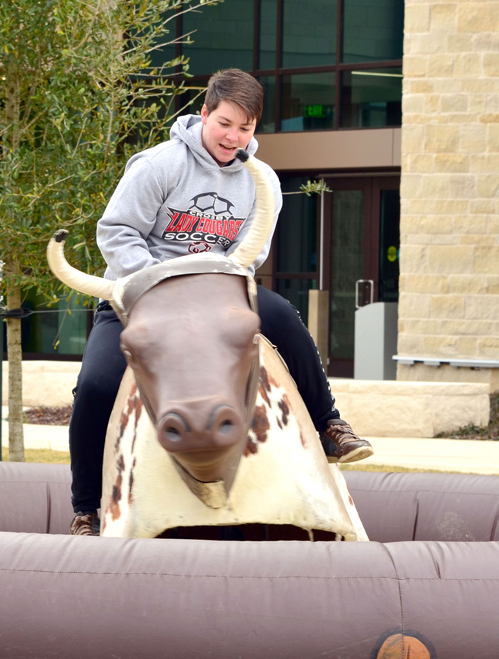 PHOTO: Shae Willingham tests their luck on the bull-riding activity at the the Winter Wonderland celebration held Jan. 30. 2019. Photo by The Signal reporter Jennifer Martinez.