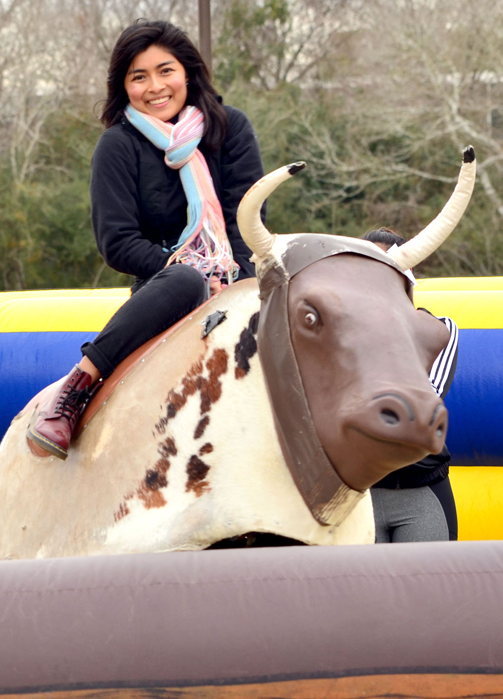 PHOTO: A UHCL student tests her balance on the bull-riding activity at the the Winter Wonderland celebration held Jan. 30. 2019. Photo by The Signal reporter Jennifer Martinez.