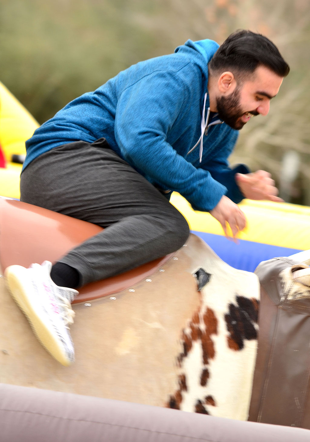 PHOTO: A UHCL student tests his balance on the bull-riding activity at the the Winter Wonderland celebration held Jan. 30. 2019. Photo by The Signal reporter Jennifer Martinez.