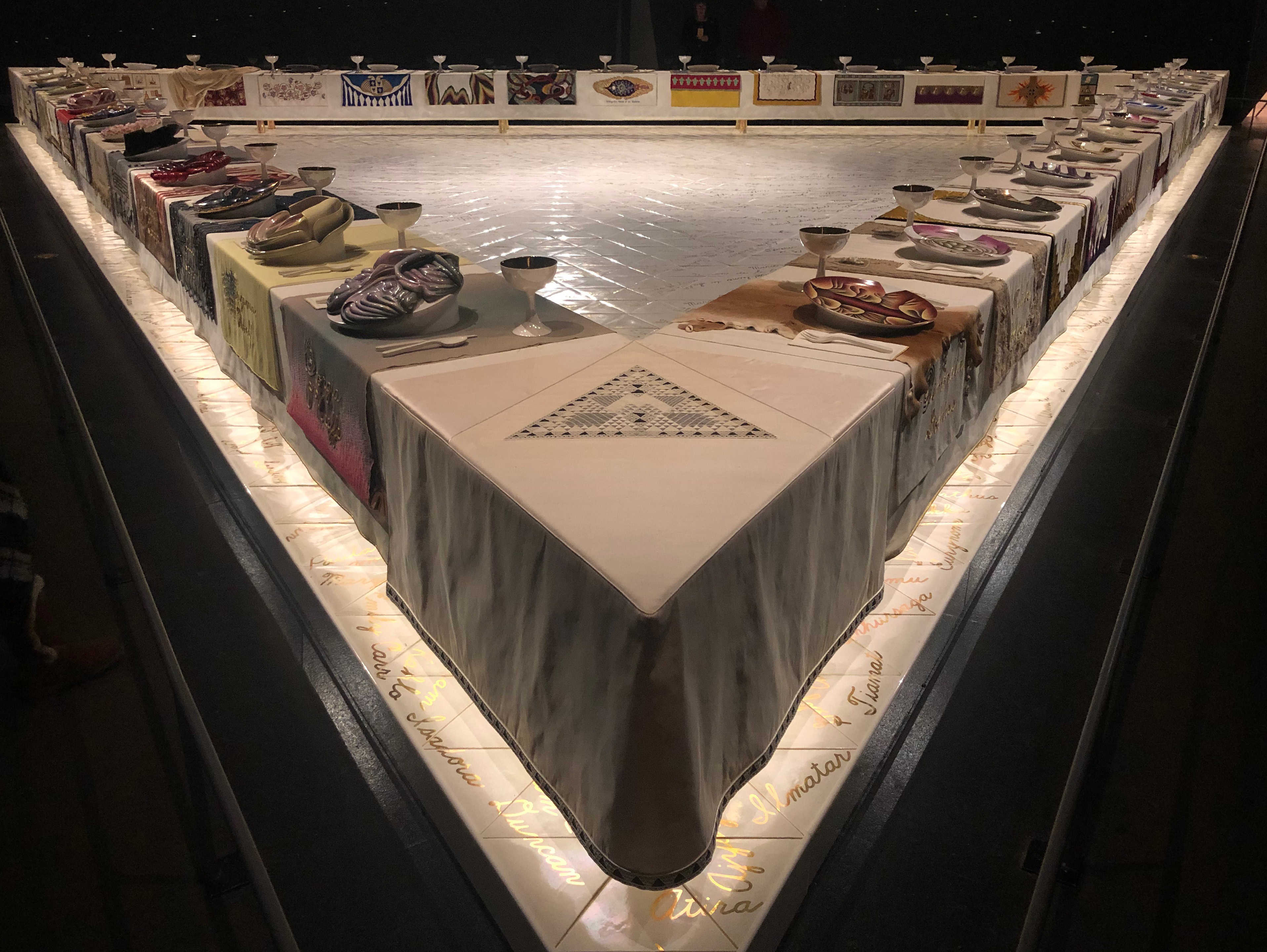 PHOTO: Each side or "wing" of "The Dinner Party" represents different sections of history. Wing One has women from prehistory to classical Rome, Wing Two women from Christianity to The Reformation and Wing Three from The American Revolution to the Women's Revolution. PHOTO: Photo of Georgia O'Keeffe's place at Judy Chicago's "The Dinner Party" installation at the Brooklyn Museum. O'Keeffe was one of a handful of women with place settings that was living at the time of its creation. Place setting features a large mauve plate with a vaginal opening. Photo by of The Signal Advisor Lindsay Humphrey.