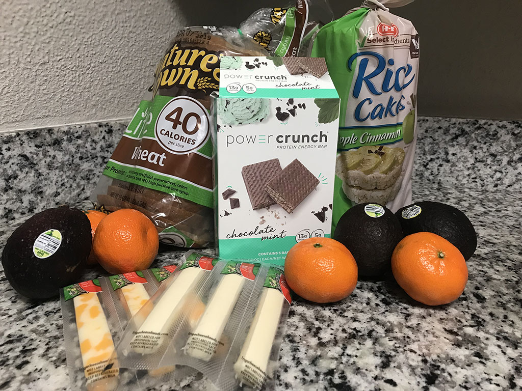PHOTO: Pictured here is a list of healthy and affordable snack options. Snacks include, cheese sticks, protein bars, mandarins, avocados and rice cakes. Photo by the Signal reporter Hailey Lamoree.