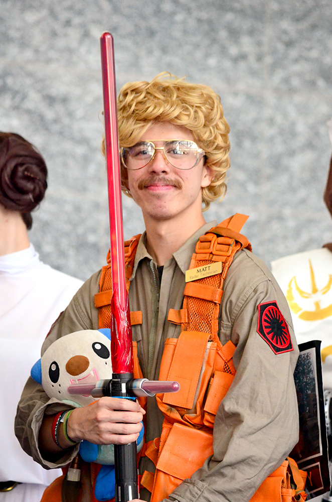 PHOTO: A cosplayer dressed as “Matt the Radar Technician” from Saturday Night Live’s Star Wars The Force Awakens skit poses with Kylo Ren’s lightsaber. Photo by The Signal reporter Jennifer Martinez.