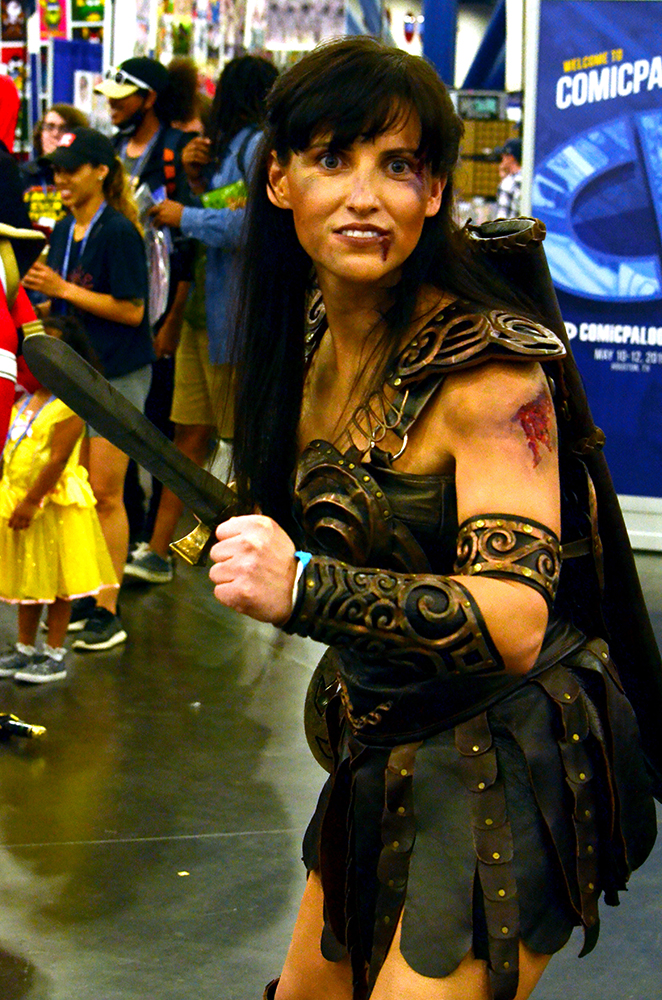 PHOTO: A woman dressed as Xena the Warrior Princess poses with a sword. In addition to Xena’s iconic leather armor, she is wearing makeup to make it look like she went through a brutal battle. Photo by The Signal reporter Jennifer Martinez.