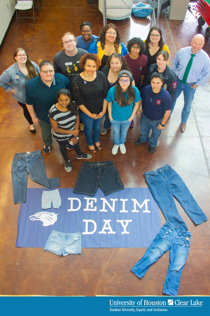 PHOTO: Staff members pose for a group photo display their jeans in honor of Denim Day. Photo courtesy of Joshua Quinn.