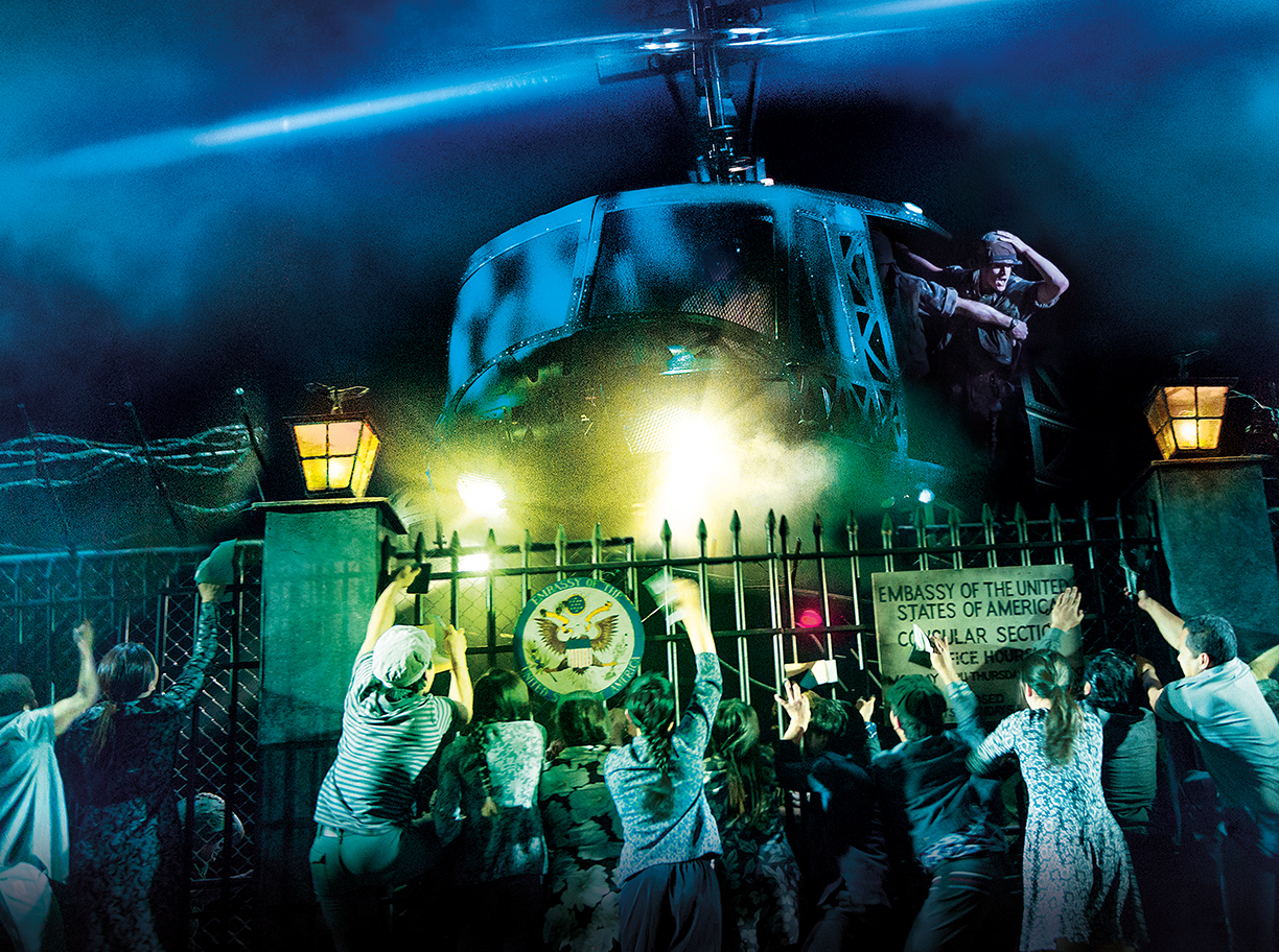 PHOTO: This moment of the musical depicts what is called "The Fall of Saigon" or the "Liberation of Saigon" depending on which side is describing it. Within a few days, Americans completely evacuated South Vietnam, many of which through helicopters on rooftops. This marked the end of The Vietnam War as Vietnam reunified. About a quarter of a million South Vietnamese were sent to "re-education camps" for being allied with Americans. Photo shows people on stage clinging to U.S. Embassy gate begging to be taken with the Americans leaving on the helicopter. Photo courtesy of Matthew Murphy and Johan Persson.