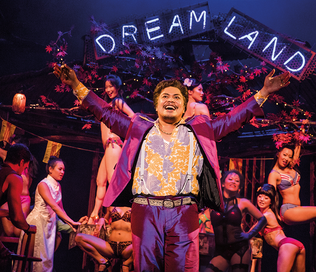 PHOTO: Red Concepción as ‘The Engineer’ in the North American Tour of Miss Saigon. Through the hopes of using Kim's child to gain an American visas, he later helps the woman he sells find her husband, Chris. Photo shows The Engineer at the start of the musical in his brothel called "Dreamland" with his prostitutes behind him. Photo courtesy of Matthew Murphy.