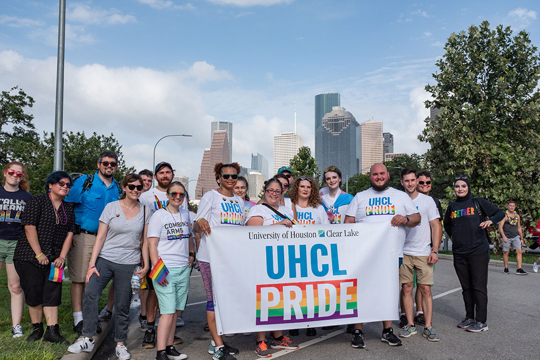 PHOTO: Standing on Allen Parkway, the UHCL Pride team, put pride stickers and glitter on, ready to begin the parade. Photo by The Signal reporter Kirk McDaniel.