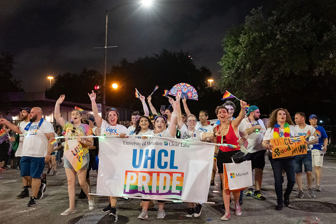 PHOTO: Walking along Smith Street in downtown Houston, Hawks represented UHCL by carrying and wearing a “UHCL Pride” banner and shirt. Photo by The Signal reporter Kirk McDaniel.