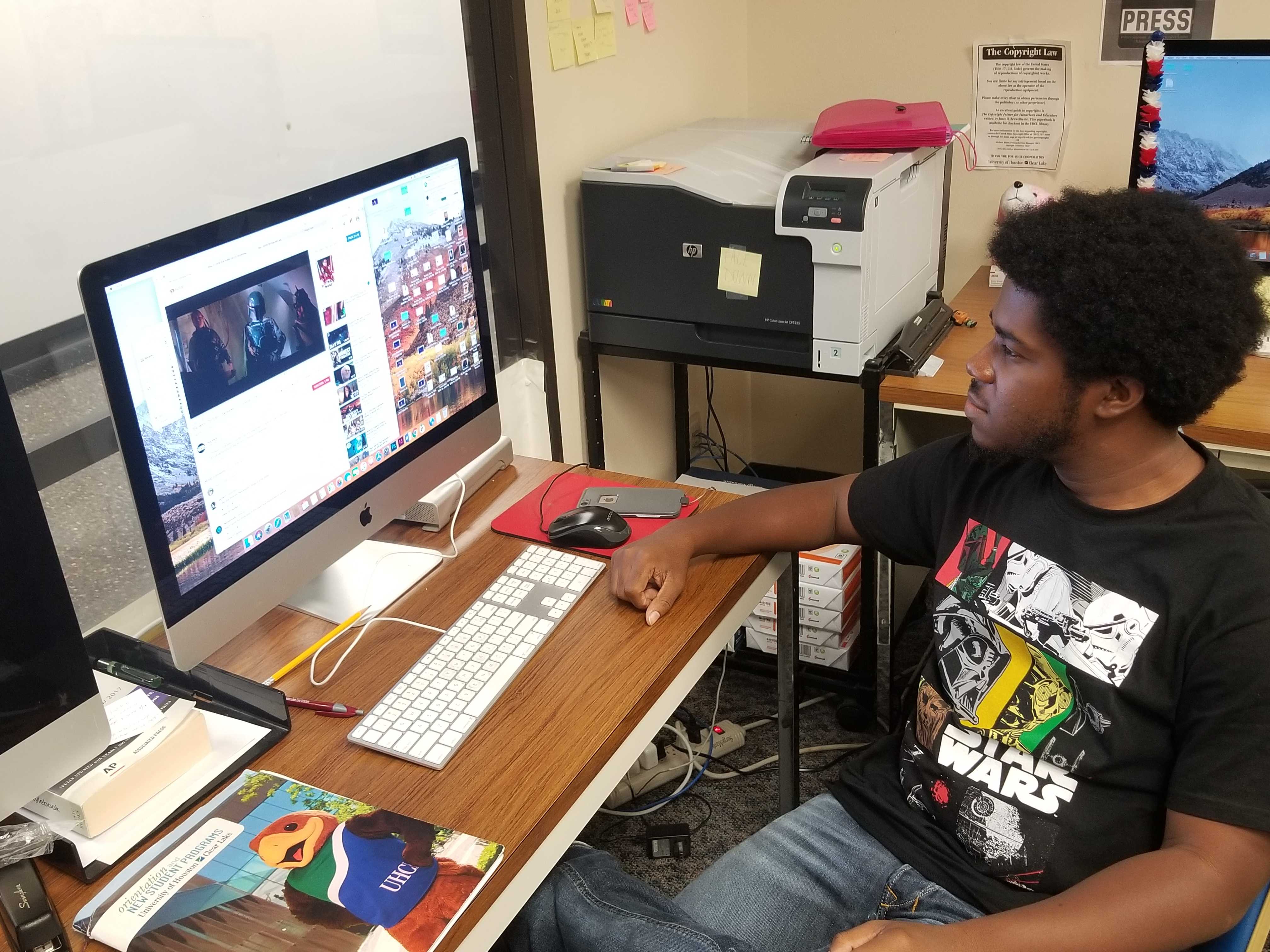PHOTO: Signal co-managing editor Troylon Griffin II watches the d23 footage for "Star Wars: The Rise of Skywalker." Photo by The Signal reporter Ethan Duke.
