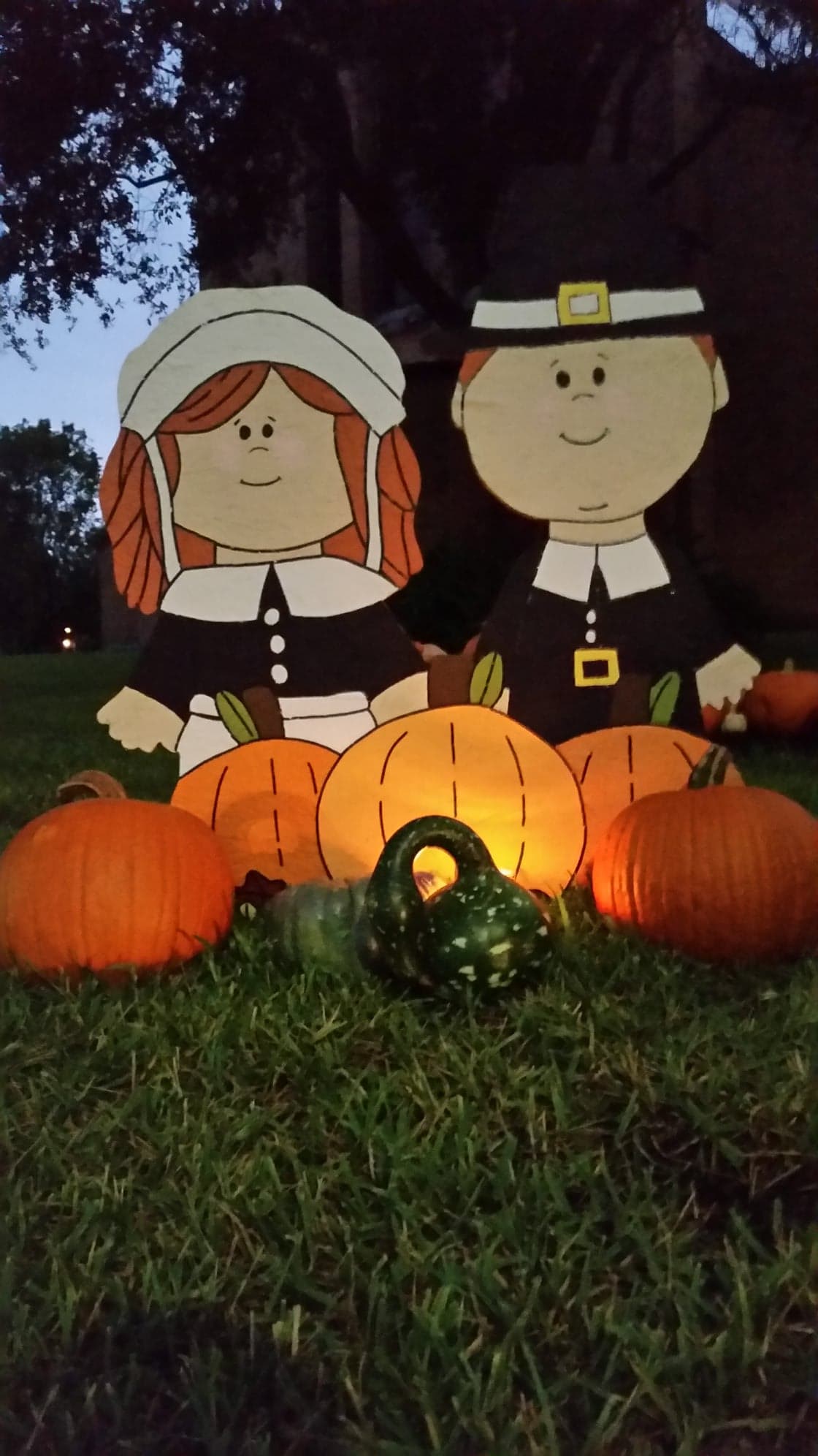 PHOTO: Boy and girl pilgrim wooded cutout and pumpkins.