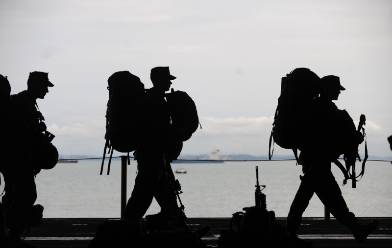 PHOTO: Silhouette of soldiers walking by a body of water. Photo courtesy of Pixabay via Pexels.com. SOURCE: https://www.pexels.com/photo/sea-people-service-uniform-40820/