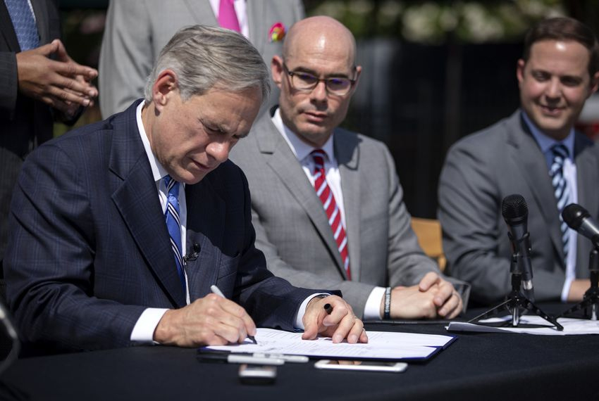PHOTO: Abbott signing SB 2. Photo courtesy of The Texas Tribune and photographer Miguel Gutierrez Jr. https://www.texastribune.org/2019/06/12/abbott-signs-property-tax-bill-sb2/