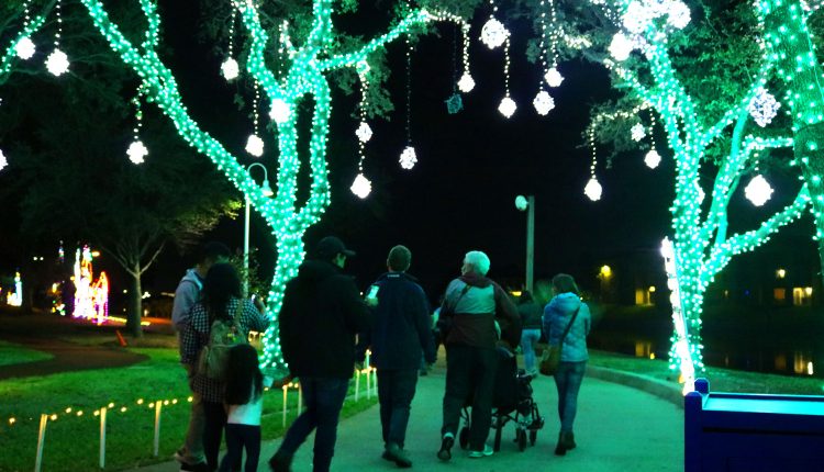 PHOTO: A family walks down the trail of Christmas lights at Moody Gardens in Galveston. Photo by The Signal reporter Emily Dundee.